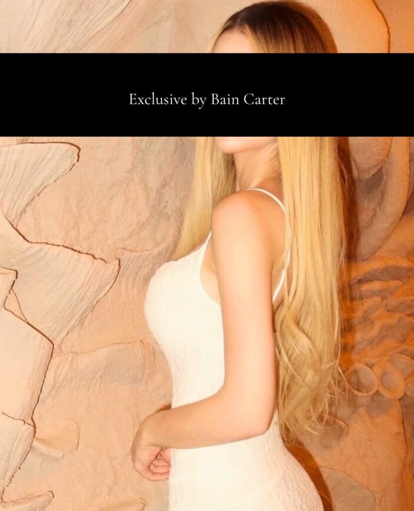 Elegant luxury escort wearing white evening dress with sophisticated vip companion style