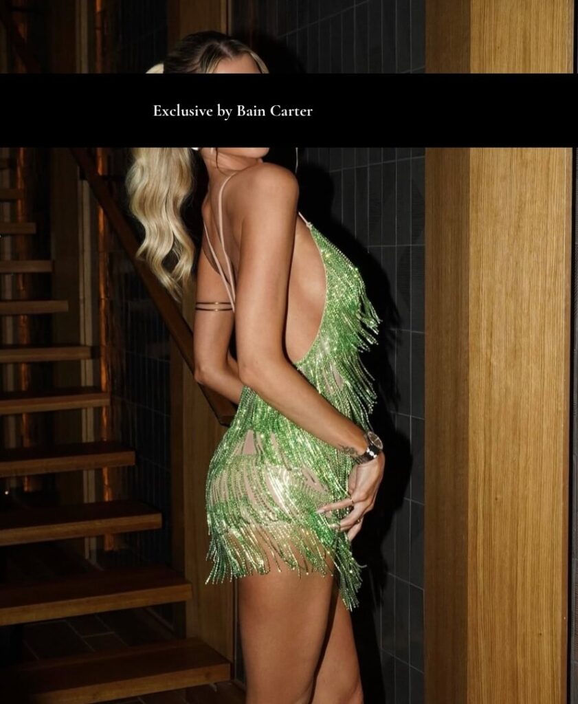 High end escort wearing elegant green luxury dress with refined vip companion style