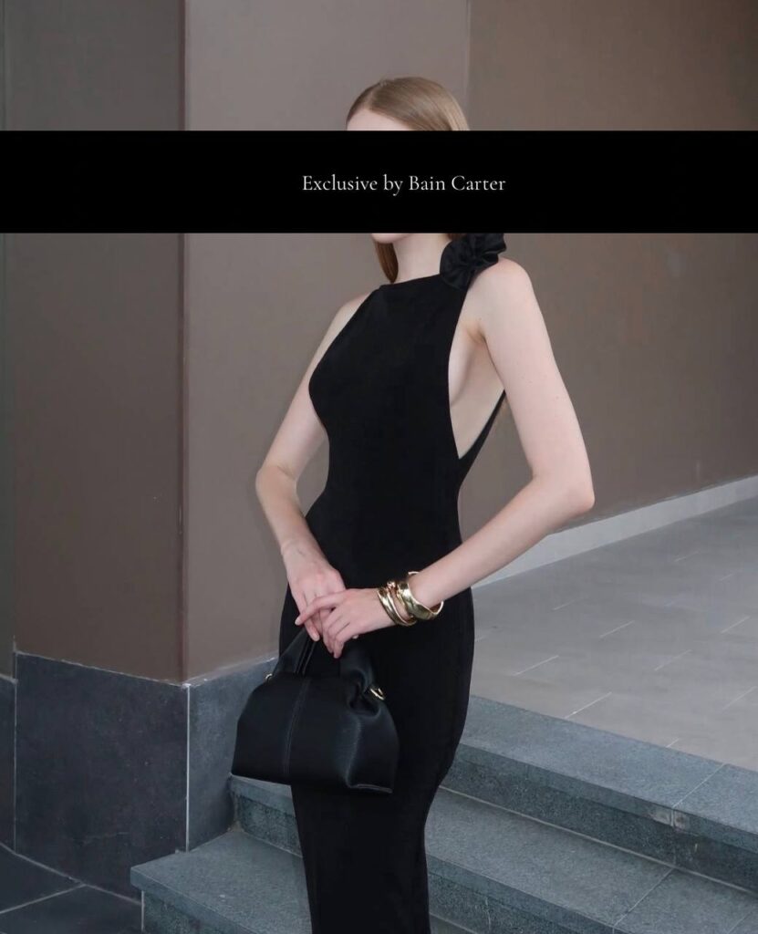 High end escort wearing elegant black dress with sophisticated vip companion style