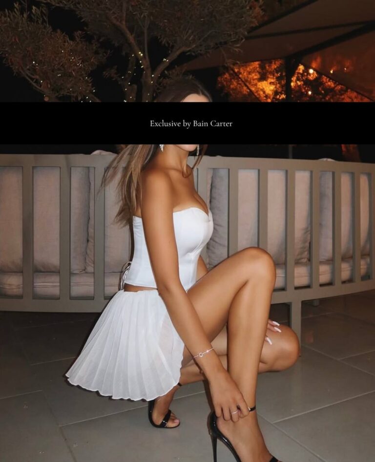 Camille luxury escort Madrid elegant white dress sunset view