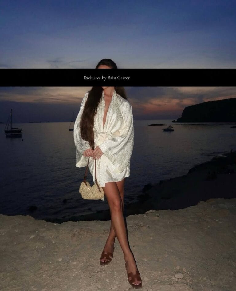 Bianca in Ibiza wearing a white dress at sunset