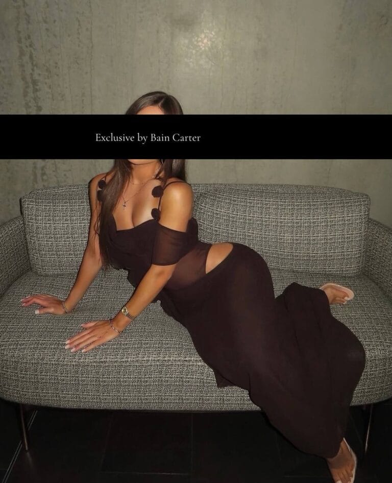 Italian escort Giulia wearing a long black dress.