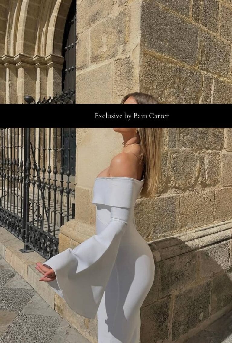 White dress photographed beside a historic stone facade