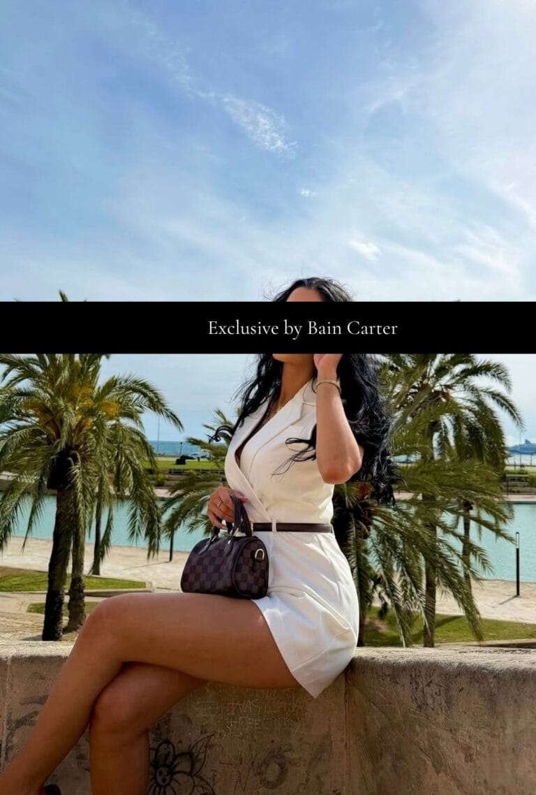 Paula wearing a white dress with palm trees in Marbella