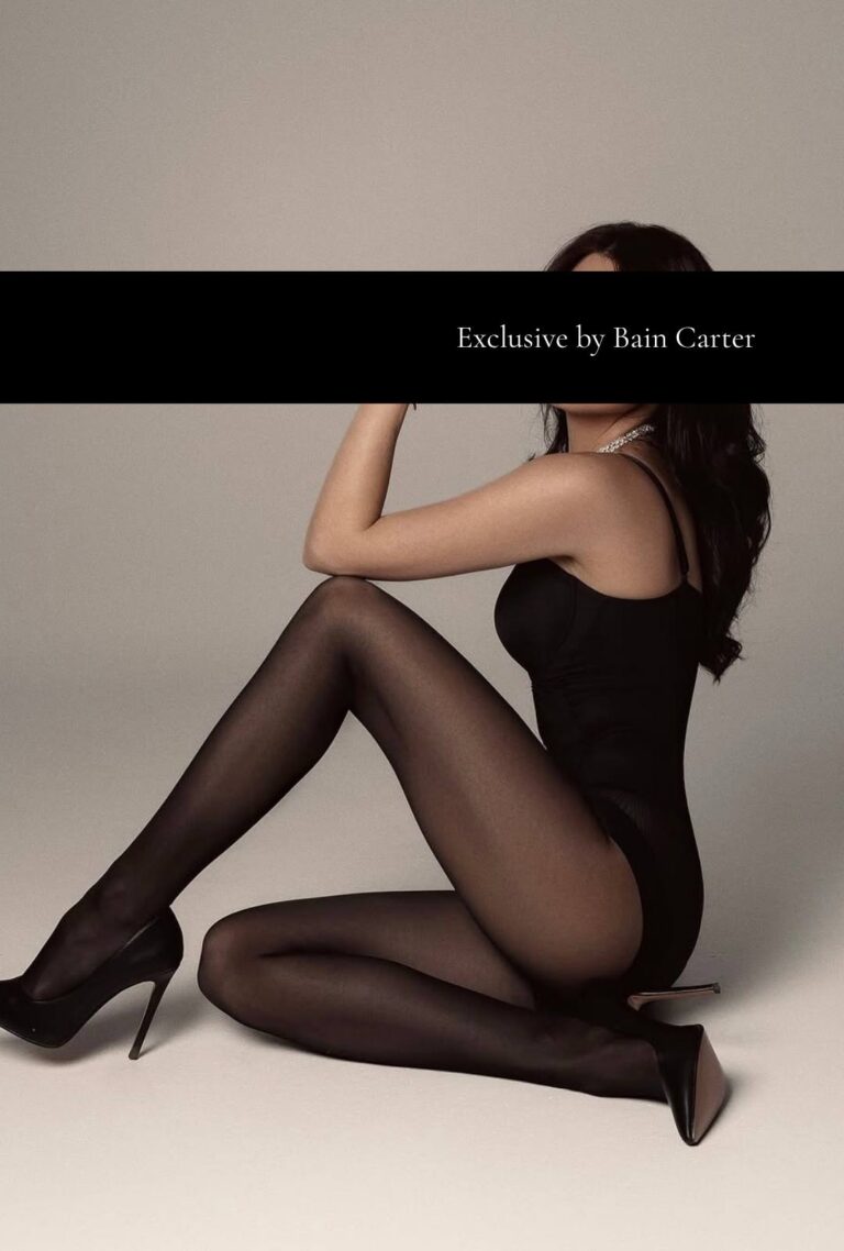 Yaryna wearing a black bodysuit and heels during a professional photoshoot